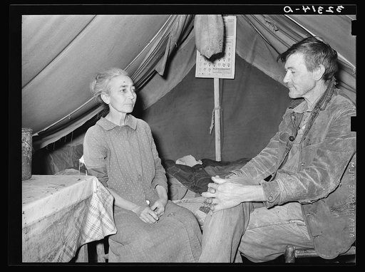 White migrant and his wife in camp near Sebastian, Texas. Both are west Texans who have come to the valley for the winter vegetable harvest