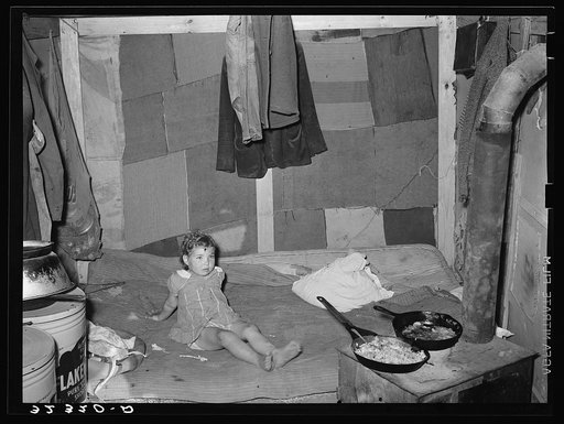 Interior of tent of white migrant family near Edinburg, Texas. Bed is on the floor. Tent was made of patched cotton materials of various sorts. The man said he had worked in a cotton mill in Dallas, Texas, and had obtained the materials then