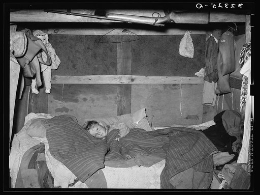Sick child in bed in trailer home. Sebastian, Texas