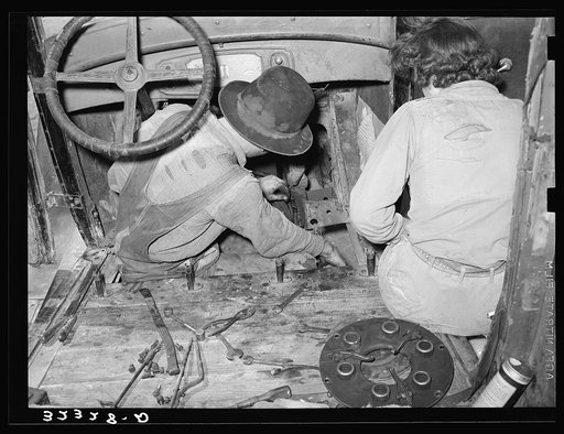 White migrant and wife repairing clutch in their car near Harlingen, Texas