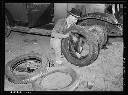 White migrant changing tires. Edinburg, Texas