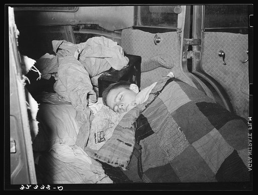White migrant boy asleep in car. He came with his father from Houston to Edinburg, Texas