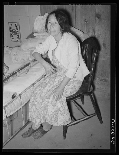 Mexican woman in bedroom. Notice the dirt floor. Crystal City, Texas