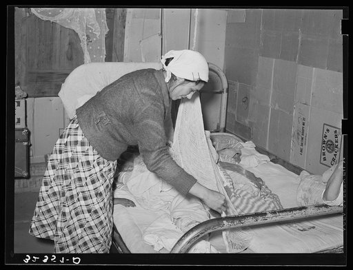 Mexican mother covering sleeping child. Crystal City, Texas