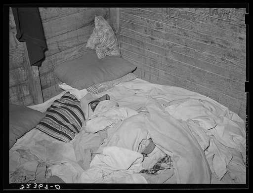 Bed in Mexican home. In practically all Mexican homes the beds consist of old blankets and quilts that are spread upon the bare floors. Crystal City, Texas