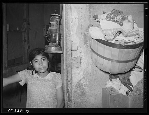 Mexican girl in doorway of home. Crystal City, Texas