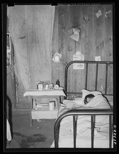 Tubercular Mexican in bed at home. Crystal City, Texas. Windows are tightly closed