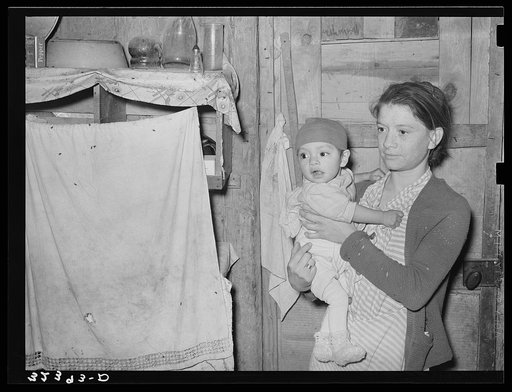 Mexican mother and child in their home. Note flies which are prevalent in all these Mexican homes. Crystal City, Texas