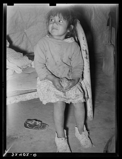 Mexican child in bed. Note dirt floor. Crystal City, Texas