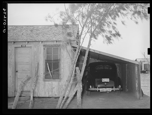 House, garage and new car of Mexican. Crystal City, Texas. It is common practice for the Mexicans on returning from the beet fields of Minnesota and North Dakota and Colorado to make first payments on cars. Even the more prosperous Mexicans live in these one- and two-room shacks