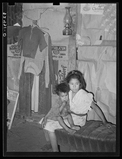 Mexican children living on outskirts of San Antonio, Texas. Notice the dirt floor
