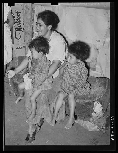 Mexican mother with her children in their home in the outskirts of San Antonio, Texas