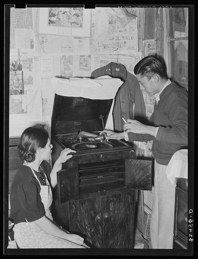 Mexican boy and girl playing phonograph. San Antonio, Texas. The Mexicans love all forms of music
