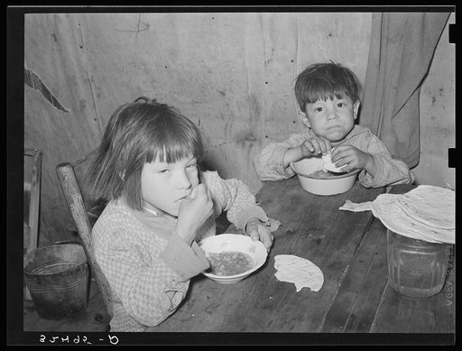 Mexican children eating lunch consisting of beans and tortillas. San Antonio, Texas