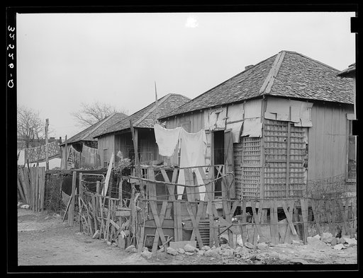 Untitled photo, possibly related to: Row of Mexican houses. San Antonio, Texas. Notice crude fences and state of disrepair of houses