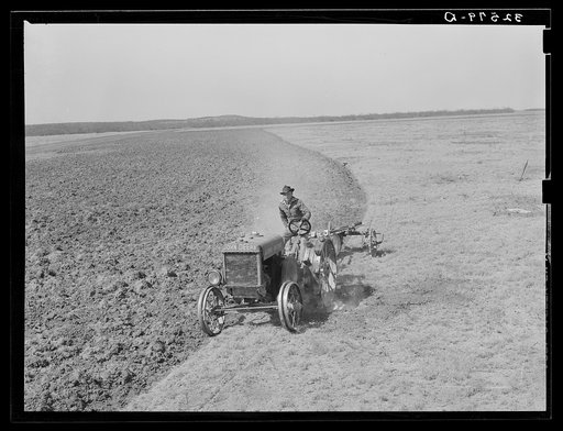 Breaking virgin soil by means of tractor-drawn plow. El Indio, Texas