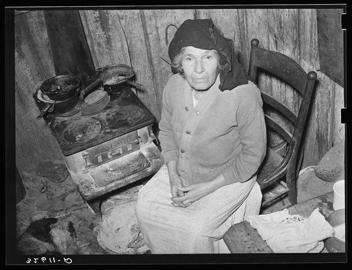 Mexican woman sitting in front of stove. San Antonio, Texas