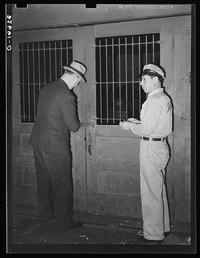 Unlocking the door of a commission house opposite the vegetable market. San Antonio, Texas