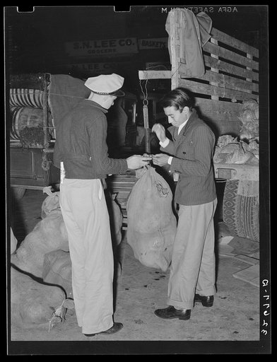 Mexican cabbage peddler being paid for his wares at market. San Antonio, Texas