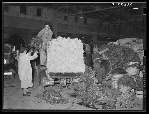 Unloading trucks at vegetable market. San Antonio, Texas