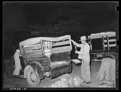 Setting up the scales on a vegetable truck at the early morning market. San Antonio, Texas