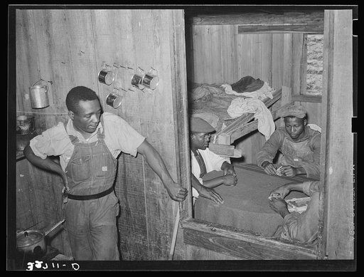 Poker game in Negro strawberry workers' bunkhouse. Note the crude bunk. Near Hammond, Louisiana