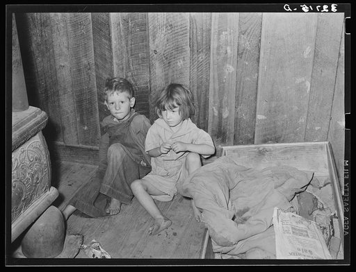 Two children of family living on relief near Jefferson, Texas. These children did not attend school because of lack of warm clothes and indifference of mother who was sick with pellagra. Note baby's cradle