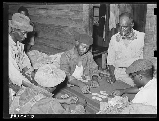Poker game in Negro strawberry workers' bunkhouse. Hammond, Louisiana