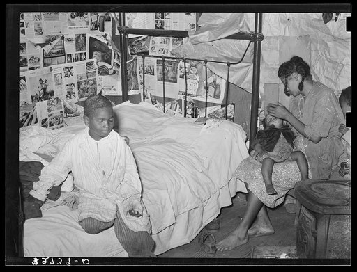 Mother and two children in house provided for workers in strawberry fields near Independence, Louisiana