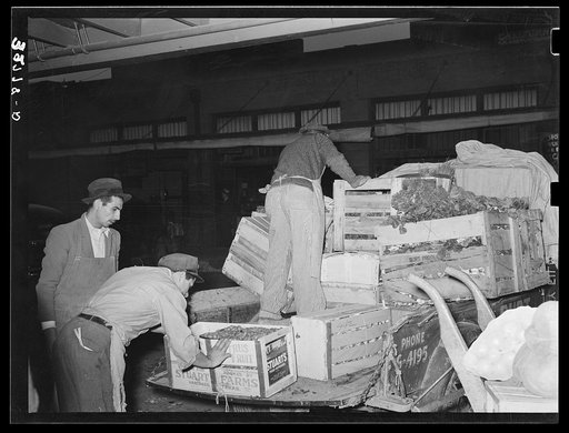 Unloading fruit and vegetables from truck. Open air market, San Antonio, Texas