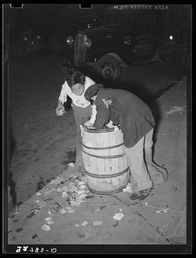 Two young Mexican boy scavengers at early morning market. San Antonio, Texas