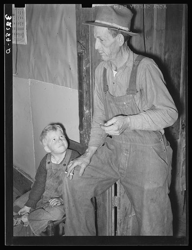 Ex-farmer and his son now living on relief. Outskirts of Jefferson, Texas
