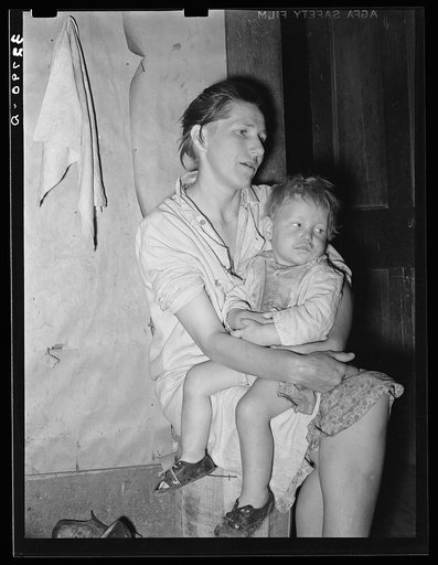 Mother and child. This woman, wife of an ex-farmer now living on relief, had pellagra in an advanced stage. She has had some treatment and shown great improvement but there were still evidences of mental disturbances. She was the mother of twelve children. The child in her arms has malaria as have p