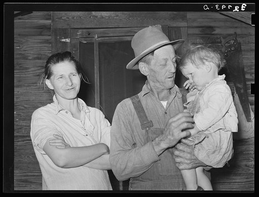 Wife and husband and child. Note condition of woman's teeth. Living on outskirts of Jefferson, Texas
