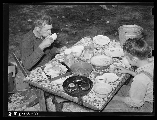 White migrant berry picker and son eating dinner near Hammond, Louisiana