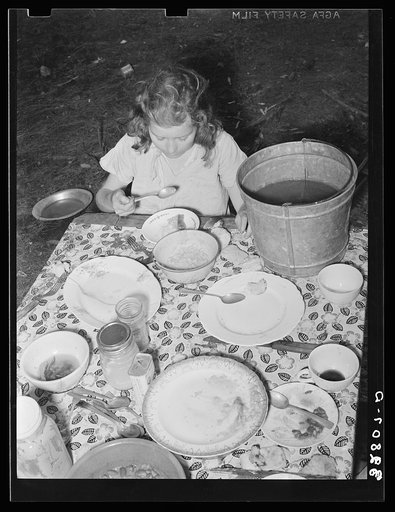 Daughter of white migrant berry picker eating dinner. Hammond, Louisiana