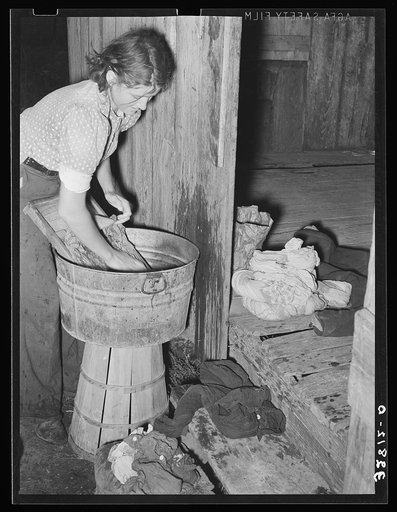 White woman, migratory berry picker, doing the laundry near Ponchatoula, Louisiana