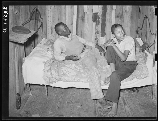 Negro strawberry pickers on bed in their quarters near Hammond, Louisiana