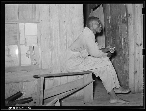 Negro strawberry sharecropper on front porch of his home near Hammond, Louisiana. He said that in a good year he came out with maybe two hundred dollars