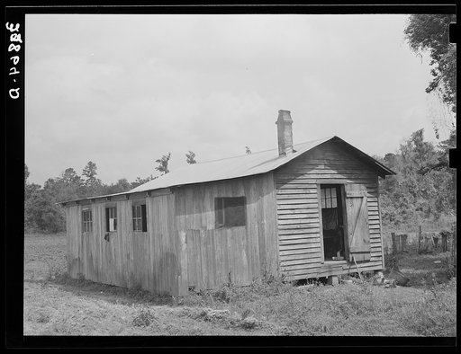 Living quarters for Negro strawberry pickers near Hammond, Louisiana.  Section on left is bunkhouse for Negro men, on right two families live