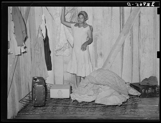 Negro woman, strawberry picker, arranging her living quarters near Hammond, Louisiana