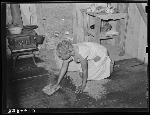 Negro woman, strawberry picker, scrubbing the floor of her living quarters near Hammond, Louisiana