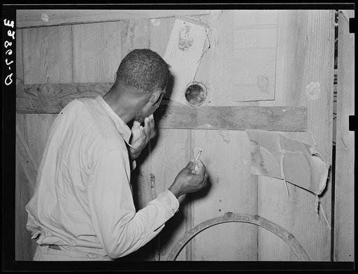 Negro strawberry picker shaving near Hammond, Louisiana