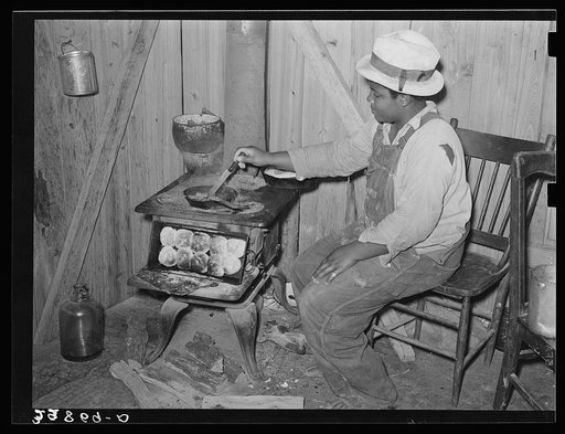 Negro woman preparing dinner for her family. Hammond, Louisiana. This family lived on the farm and did odd jobs
