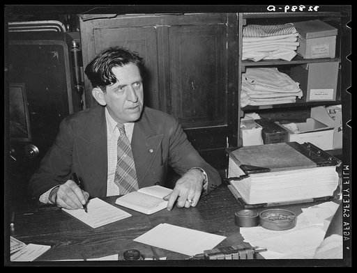 Department store owner at desk. San Augustine, Texas