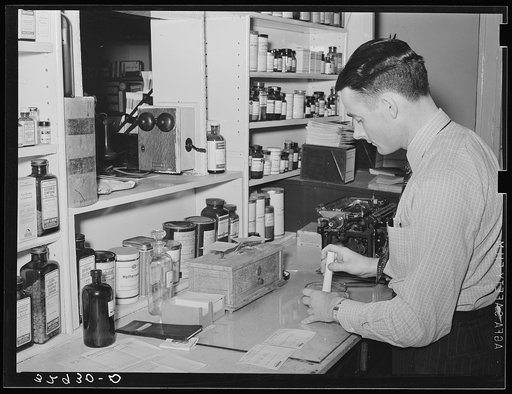 Druggist making up prescription. San Augustine, Texas