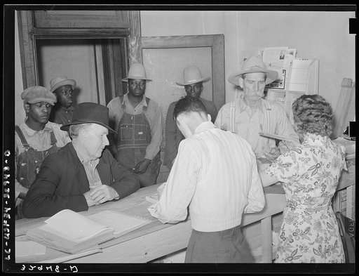 Scene in county agent's office, San Augustine, Texas. Farmer is receiving his AAA check