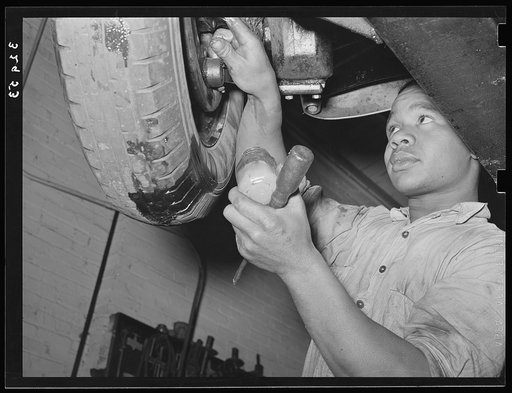 Greasing automobile in garage. San Augustine, Texas