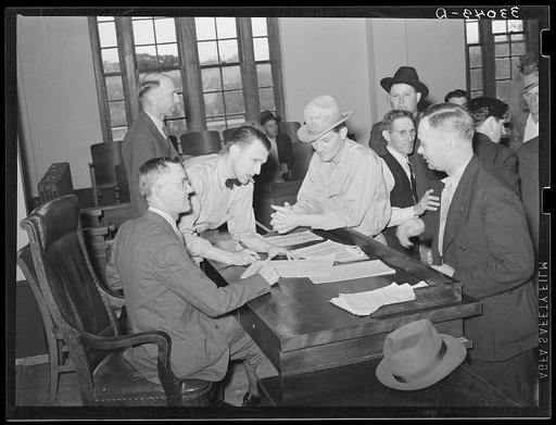 Discussion at the county judge's desk after the mass meeting. San Augustine, Texas