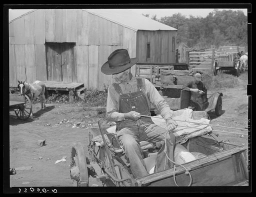 Farmer with loaded wagon leaving town. San Augustine, Texas